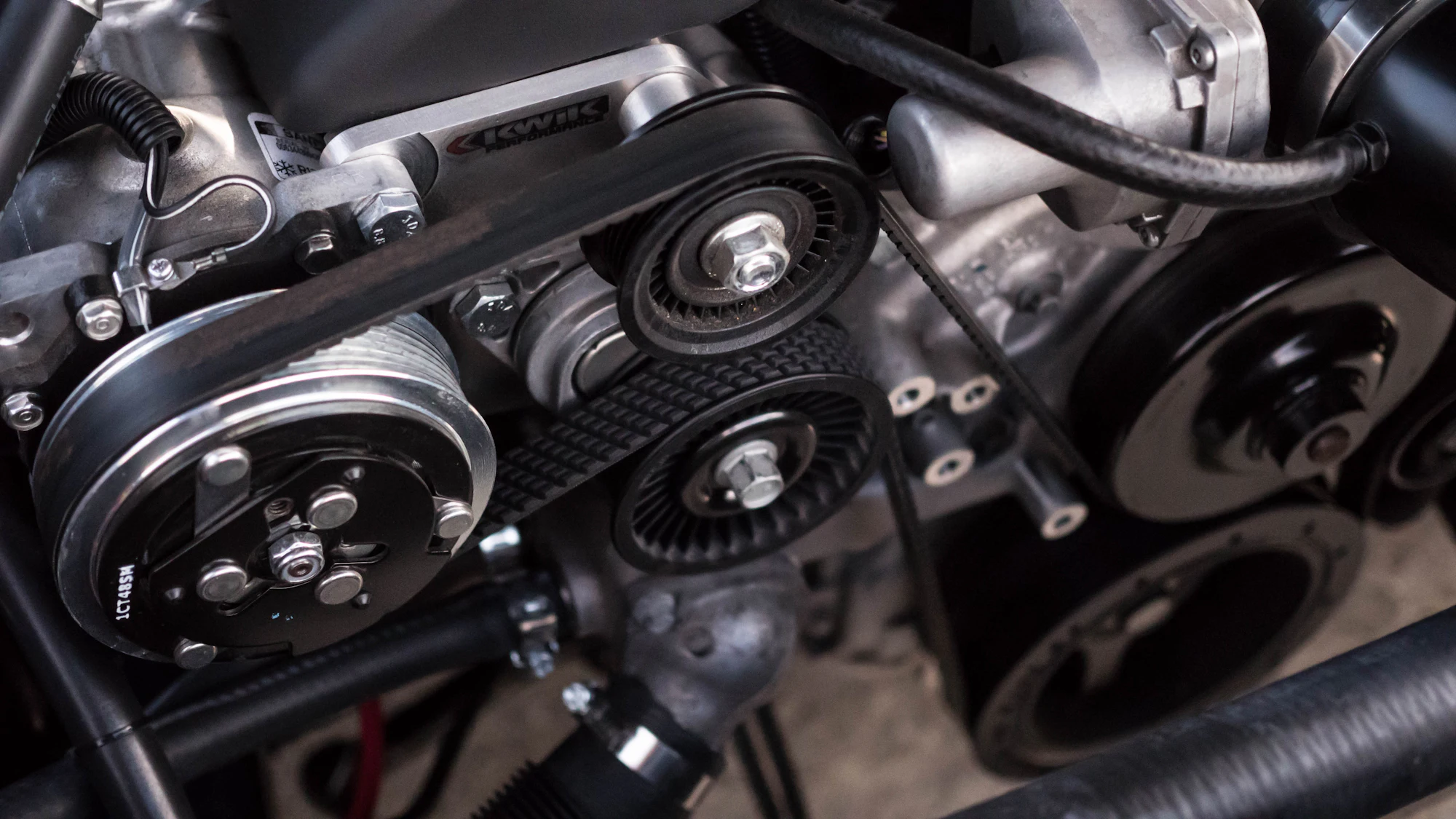 Close-up of an engine's belt drive and pulleys.