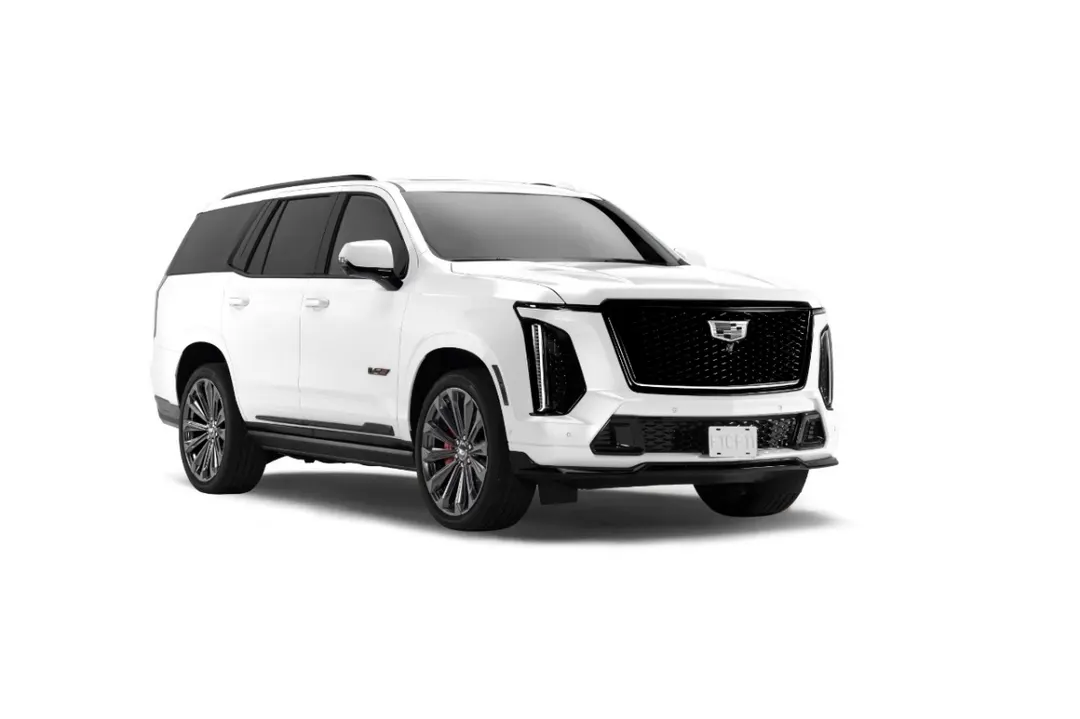 A white Cadillac Escalade-V Checo Pérez Edition with a black grille and dark 24-inch wheels, seen from the front three-quarter on a white background