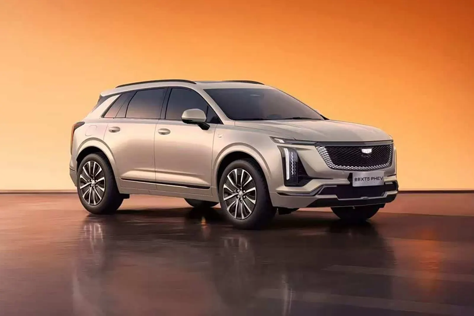 A champagne-colored China-market 2027 Cadillac XT5 PHEV crossover shown front three-quarter in a studio with an orange backdrop