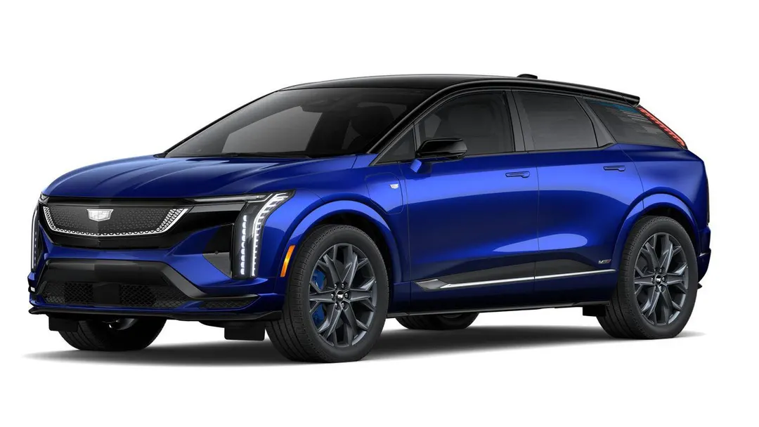 A 2027 Cadillac Optiq-V in deep blue paint with a black roof, shown from the front three-quarter angle on a white background